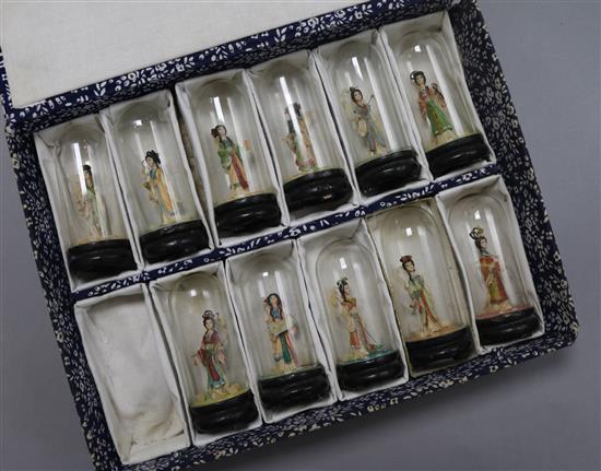 Eleven Japanese wax miniature figures under domes overall height 9.5cm